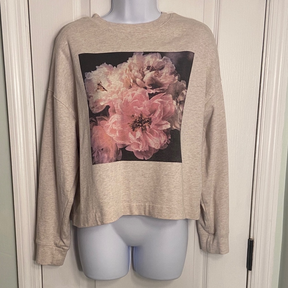Beige sweater with pink flower logo design. Excellent condition size small